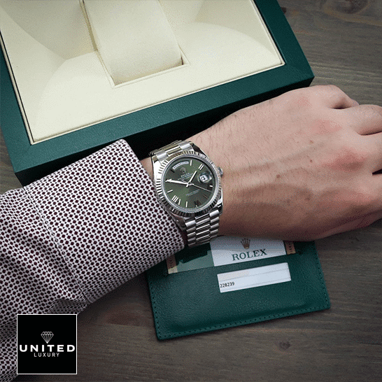 Rolex Olive Green Replica 9 Rolex Day-Date Olive Green 228239 Replica Rolex Box in front of on is arm