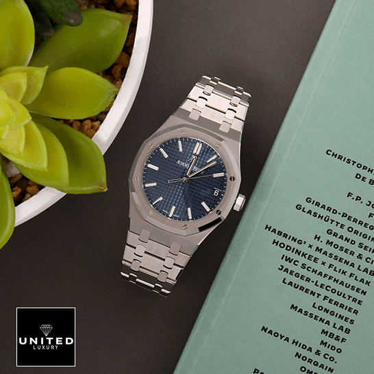 AP Royal Oak 15500 Replica 5 Audemars Piguet Royal Blue Dial Steel Bezel Replica next to flowers